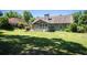 Expansive backyard featuring a well-maintained lawn, a covered patio area, and partial fencing, perfect for Gathering gatherings at 3335 Ivy Lake Dr, Buford, GA 30519