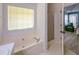 Corner bathtub with a view to the bedroom and glass shower at 3335 Ivy Lake Dr, Buford, GA 30519