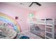 Bright bedroom featuring bunk beds, a colorful rug and an accent rainbow at 3335 Ivy Lake Dr, Buford, GA 30519