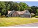 Attractive single-Gathering home featuring a well-manicured lawn, brick accents, and a spacious two-car garage at 3335 Ivy Lake Dr, Buford, GA 30519