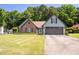 Charming single-Gathering home featuring a well-manicured lawn, brick accents, and a spacious two-car garage at 3335 Ivy Lake Dr, Buford, GA 30519