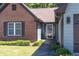 Close up of a home's entrance featuring brick accents, a storm door, and an attractive, well-maintained lawn at 3335 Ivy Lake Dr, Buford, GA 30519