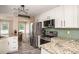Well-lit kitchen showcasing stainless steel appliances, granite countertops, and a modern backsplash at 3335 Ivy Lake Dr, Buford, GA 30519