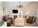 Bright living room featuring a brick fireplace, comfortable seating, and hardwood floors with views of the kitchen at 3335 Ivy Lake Dr, Buford, GA 30519