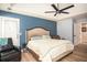 Comfortable main bedroom featuring a ceiling fan and views to sitting area and exterior at 3335 Ivy Lake Dr, Buford, GA 30519