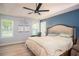 Spacious main bedroom with a ceiling fan, natural light, and stylish décor at 3335 Ivy Lake Dr, Buford, GA 30519