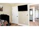 Office space featuring a large monitor and a view of the hallway to the bathroom at 3335 Ivy Lake Dr, Buford, GA 30519