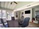 Enclosed sunroom showcasing vaulted ceiling, neutral paint, hardwood-style floors, and windows offering natural light and views at 3335 Ivy Lake Dr, Buford, GA 30519