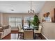 Dining area with a glass table, four chairs, ample sunlight, and an adjacent living room at 805 Pleasant Hill Nw Rd # 343, Lilburn, GA 30047