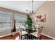 Bright dining area with hardwood floors, chandelier, and natural light from windows at 805 Pleasant Hill Nw Rd # 343, Lilburn, GA 30047