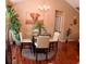 A cozy dining area with a glass-top table, four chairs, chandelier, and a lovely elephant painting at 805 Pleasant Hill Nw Rd # 343, Lilburn, GA 30047