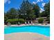 Community swimming pool with lounge chairs and lush landscaping at 805 Pleasant Hill Nw Rd # 343, Lilburn, GA 30047