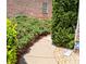Exterior walkway surrounded by lush green landscaping, bushes and brick building at 805 Pleasant Hill Nw Rd # 343, Lilburn, GA 30047