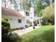 Charming backyard with a patio, lawn, and mature trees surrounding the home at , Loganville, GA 30052