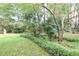 Landscaped backyard featuring mature trees and a lawn, providing a serene outdoor space for this property at , Loganville, GA 30052
