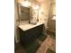 Elegant bathroom featuring a double vanity, decorative mirrors, and wood-like flooring at , Loganville, GA 30052