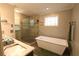 Luxurious bathroom featuring a standalone tub, walk-in shower, and marble countertop vanity with sink at , Loganville, GA 30052