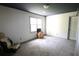 Spacious bedroom with light walls, a dark ceiling, a large window, and wood accents at , Loganville, GA 30052