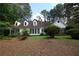 Charming traditional home featuring black shutters, dormer windows, and mature landscaping at , Loganville, GA 30052