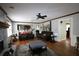 The living room showcases hardwood floors, a ceiling fan, and an adjacent kitchen at , Loganville, GA 30052