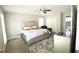 Spacious bedroom with plush carpeting, a ceiling fan, and a king bed with white linens at , Loganville, GA 30052