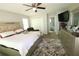 Spacious bedroom with a ceiling fan, a king bed with white linens, and neutral décor at , Loganville, GA 30052