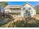 Backyard view of home with wooden deck and stairs leading down to the patio at 3133 Callie Still Rd, Lawrenceville, GA 30045