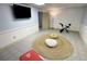Finished basement with a large area rug, workout equipment, and a mounted TV, designed for flexible use at 3133 Callie Still Rd, Lawrenceville, GA 30045