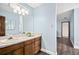 Bathroom with wood vanity, white marble countertop, oval sink, and light blue walls at 3133 Callie Still Rd, Lawrenceville, GA 30045