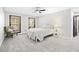 Bright bedroom includes a ceiling fan, soft carpet, and two windows with natural light at 3133 Callie Still Rd, Lawrenceville, GA 30045