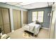 This cozy bedroom features a twin bed, large window, and multiple closet spaces for optimal storage at 3133 Callie Still Rd, Lawrenceville, GA 30045
