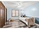 Bright bedroom features unique plank flooring, neutral walls, ceiling fan, and decorative pillows at 3133 Callie Still Rd, Lawrenceville, GA 30045