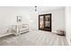 Light-filled bedroom includes a crib, neutral walls, soft carpet, and access to a private balcony at 3133 Callie Still Rd, Lawrenceville, GA 30045