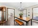Bright dining room featuring a dining table and bench, large windows, and modern light fixture at 3133 Callie Still Rd, Lawrenceville, GA 30045
