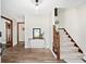 Welcoming foyer with hardwood floors, staircase, and elegant decor creates a warm entry at 3133 Callie Still Rd, Lawrenceville, GA 30045