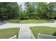 Large driveway surrounded by mature trees and landscaped areas, offering a serene setting at 3133 Callie Still Rd, Lawrenceville, GA 30045