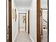Hallway with hardwood floors, white walls, and wood trim, leading to various rooms at 3133 Callie Still Rd, Lawrenceville, GA 30045