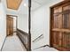 Upstairs hallway features wooden banister, neutral carpet, and access to bedrooms at 3133 Callie Still Rd, Lawrenceville, GA 30045