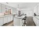 Bright kitchen with white cabinets, granite countertops, and a center island with bar stool seating at 3133 Callie Still Rd, Lawrenceville, GA 30045