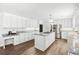 Bright kitchen features granite countertops, stainless steel appliances, and a center island with gas range at 3133 Callie Still Rd, Lawrenceville, GA 30045