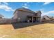 Rear view of home showcasing the spacious yard with a covered patio, great for outdoor enjoyment at 3823 Dragon Fly Ln, Loganville, GA 30052