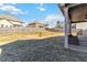 Spacious fenced backyard with a covered patio featuring comfortable seating and string lights at 3823 Dragon Fly Ln, Loganville, GA 30052