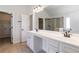 Bathroom featuring double sinks, granite countertops, a large mirror and walk-in shower at 3823 Dragon Fly Ln, Loganville, GA 30052