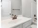 Bright bathroom with a white vanity, dark fixtures and a shower-tub combination at 3823 Dragon Fly Ln, Loganville, GA 30052