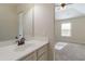 Bathroom featuring a white sink and vanity, with a view to the bright bedroom at 3823 Dragon Fly Ln, Loganville, GA 30052