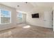 Bright bedroom featuring two large windows, a vaulted ceiling, and neutral carpeting at 3823 Dragon Fly Ln, Loganville, GA 30052