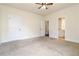 Neutral carpeted bedroom with a ceiling fan and easy access to a bathroom at 3823 Dragon Fly Ln, Loganville, GA 30052
