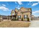 Charming two-story brick home with a covered front porch and well-maintained landscaping at 3823 Dragon Fly Ln, Loganville, GA 30052