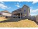 Back exterior view of a home with a large fenced yard, covered patio, and well-maintained landscaping at 3823 Dragon Fly Ln, Loganville, GA 30052