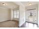 Welcoming foyer with hardwood floors, a window, and white trim at 3823 Dragon Fly Ln, Loganville, GA 30052
